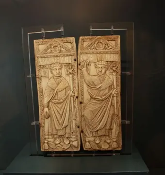 Diptych of Boethius with two carved ivory panels showing robed male figures holding staffs.