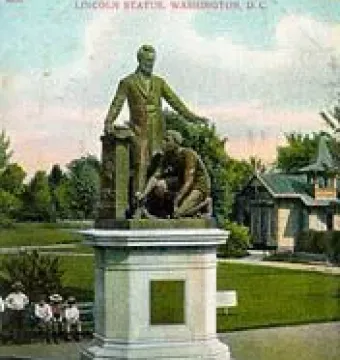 The Emancipation Memorial shows Abraham Lincoln standing over a kneeling man with a broken chain on a tall pedestal in a park.