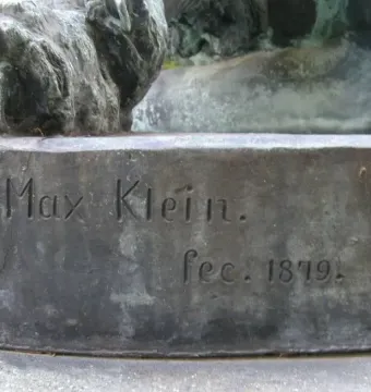 Weathered bronze base of Hercules and the Nemean Lion with the inscription \