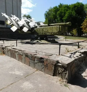 Battle of the Dnieper Diorama monument with a green military missile launcher and grey missiles on a concrete base