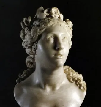 Blessed Soul marble bust of a woman with an upward gaze and curled hair