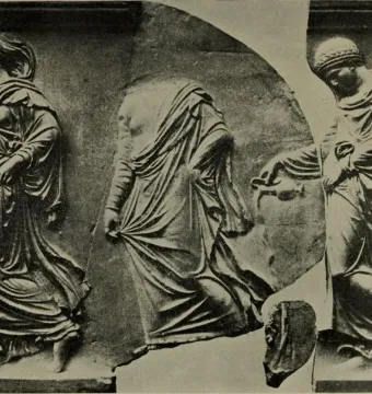 Fragmented relief sculpture of three draped female figures walking left, with the central figure headless.