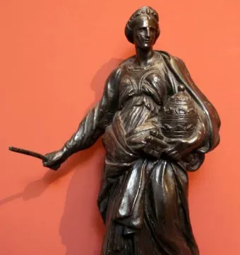 Tomb of Countess Matilda of Tuscany, a dark full-length statue of a crowned woman in flowing robes holding a rod and lidded vessel.