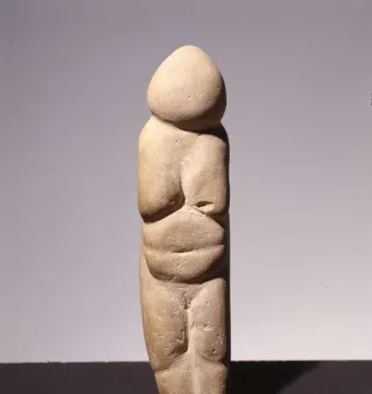 Venus of Chiozza stone figurine with a stylized standing female form and prominent breasts