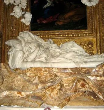 Ecstasy of Blessed Ludovica Albertoni in white marble, reclining in flowing robes within an ornate gilded niche