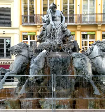Fontaine Bartholdi fountain sculpture in Lyon with a female figure in a horse-drawn chariot and flowing water
