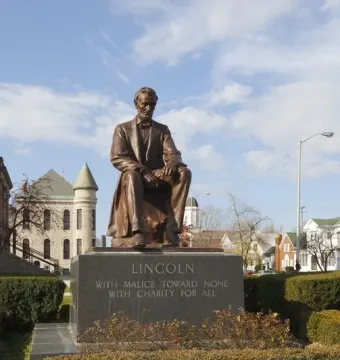Seated bronze Abraham Lincoln statue on a granite pedestal inscribed with Lincoln\'s quote.