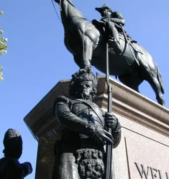 The Duke of Wellington equestrian statue on a stone plinth, with a soldier figure holding a rifle below.