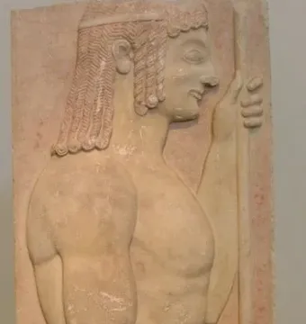 Grave stele relief of a young doryphoros in profile, holding a vertical staff against a red background.