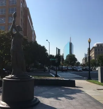 Victims of Communism Memorial statue of a robed figure holding a torch aloft.