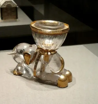 Crystal elephant sculpture with gold details and a ribbed salt cellar mounted on its back