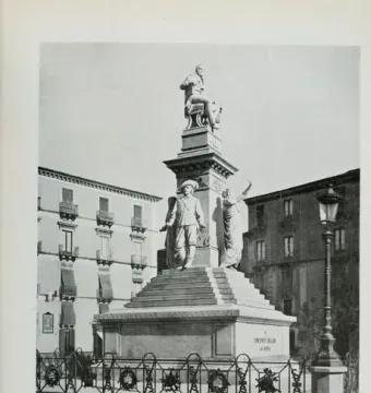 Monument to Vincenzo Bellini with a seated figure atop a tall pedestal and standing allegorical statues below