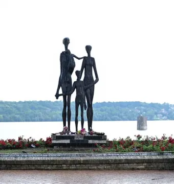 Monument to the Victims of Fascism bronze sculpture of two adults and a child beside a river