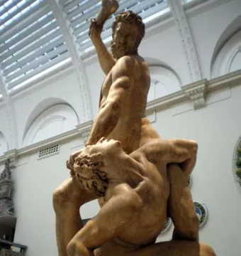 Samson Slaying a Philistine sculpture showing two muscular male figures in a dramatic struggle, with one standing over the other and raising an object to strike.