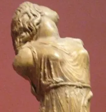 Dancing Maenad sculpture with the figure’s head tilted back and flowing drapery against a red-brown background.