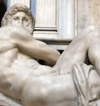 The Day from the Medici Tombs, a reclining white marble male figure with a muscular nude body and turned head.
