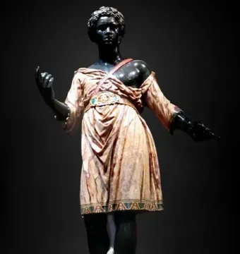 Moor of Borghese statue showing a dark-skinned figure in a patterned tunic and boots with one arm raised.