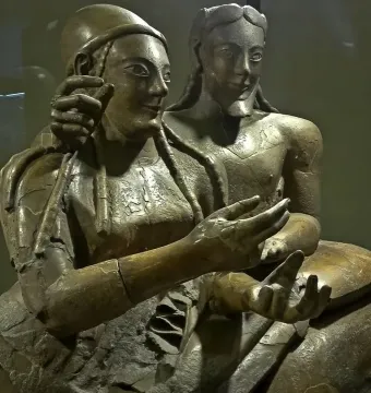 Sarcophagus of the Spouses showing two reclining terracotta figures, a man and a woman, with their arms extended.