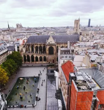 The Stravinsky Fountain with colorful whimsical sculptures spraying water in a Paris square.