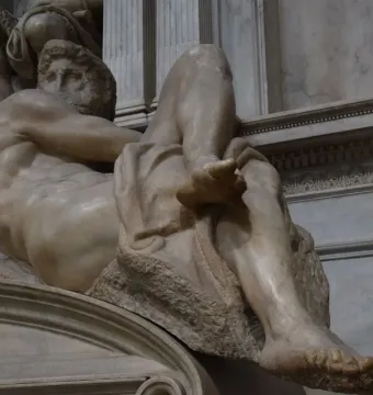 Michelangelo\'s Day, a reclining nude marble male figure in the Sagrestia Nuova.