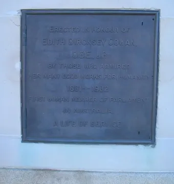 Bronze plaque on the Edith Cowan Memorial mounted on a light stone wall.