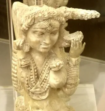 Close-up of the Pompeii Lakshmi, a carved ivory female figure with necklaces, bangles, and an elaborate hairstyle.
