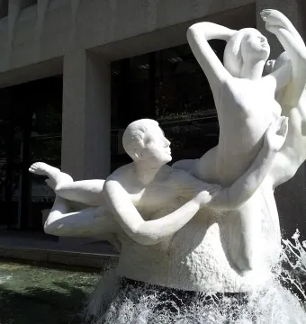 The Quest sculptural fountain with intertwined human figures and splashing water in Portland.