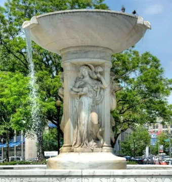 Dupont Circle Fountain with carved female figures and water flowing from its upper basin