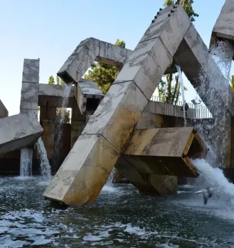 Vaillancourt Fountain with large concrete blocks and tubes sending water into a turbulent pool.