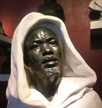 Salem, Negro of Sudan sculpture showing a dark metallic face, short beard, and white draped garment.