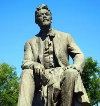 Chekhov Monument showing a seated bronze statue of Anton Chekhov holding a book and looking upward.