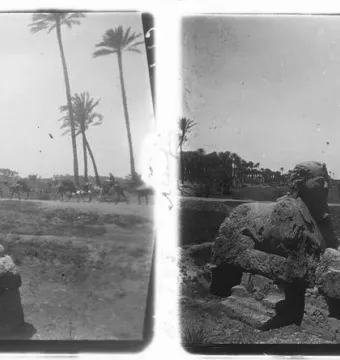 A weathered sphinx of Memphis stands in a desert landscape with palm trees and camel riders in the distance.