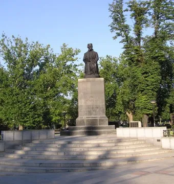Vuk Karadžić Monument with a seated bronze figure holding a book on a tall stone pedestal