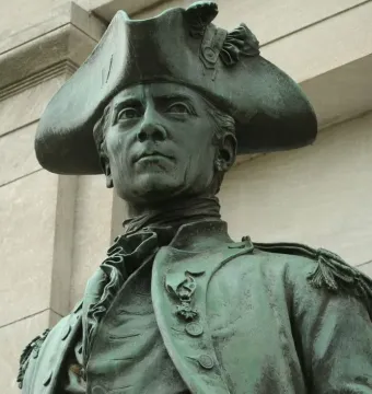 Close-up of the John Paul Jones Memorial bronze statue showing John Paul Jones in a tricorn hat and military coat.