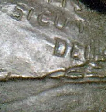 Close-up of the Monkey with a Skull sculpture showing the raised words \