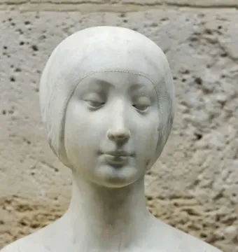 Marble bust of a young princess with her head gently lowered and eyes cast down.