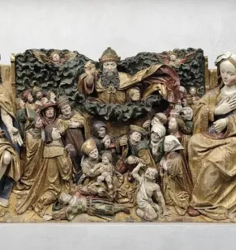 Carved wooden Last Judgement panel with Christ in a crown of thorns, a veiled woman, kneeling figures, and winged figures among dark clouds.
