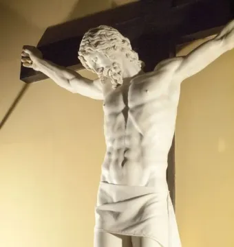 Cellini Crucifix showing a white marble Christ figure on a dark wooden cross