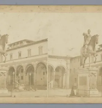 Ferdinando I de\' Medici equestrian statue on a large pedestal in a square with arched porticos and surrounding buildings.