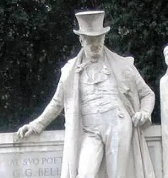 Monument to Giuseppe Gioachino Belli showing a stone statue of a man in a top hat and long coat leaning on a plinth with a cane.