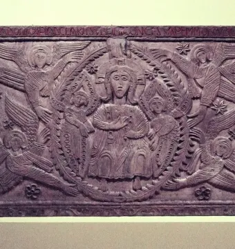 Relief panel from the Rachis Altar showing a seated central figure, two smaller figures, and surrounding winged haloed beings.