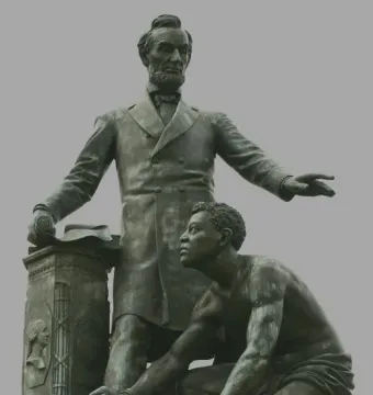The Emancipation Memorial shows Abraham Lincoln standing beside a kneeling bare-chested man holding a broken chain.