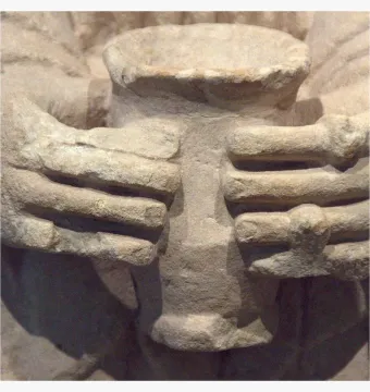 Close-up of the Lady of Cerro de los Santos showing carved hands holding a cylindrical vessel.