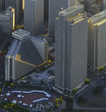 Vaillancourt Fountain in a plaza, seen from above among streets and tall buildings.
