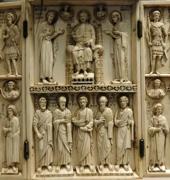 Harbaville Triptych with three carved ivory panels showing a central seated figure flanked by standing figures, busts in roundels, and inscriptions.