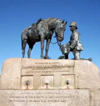 The Horse Memorial shows a saddled horse beside a kneeling soldier holding a bucket on a stone plinth with inscriptions.