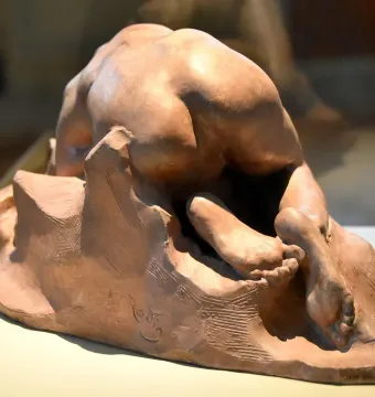 Danaid by Auguste Rodin, a terracotta sculpture of a nude female figure bent forward against a rock-like base.
