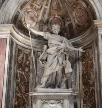Marble statue of St. Longinus holding a spear in a decorated niche at St. Peter\'s Basilica.