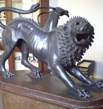 Chimera of Arezzo bronze sculpture showing a lion with a goat’s head on its back and a snake tail.