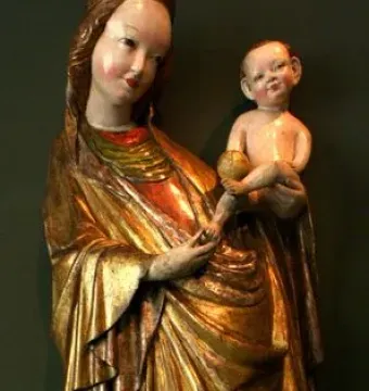 Madonna of Krużlowa holding the Christ Child, shown in flowing gold and red robes.
